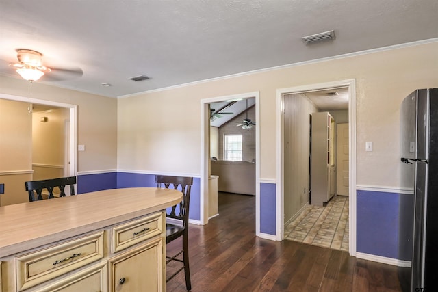 dining room with lofted ceiling, ceiling fan, crown molding, and dark hardwood / wood-style flooring