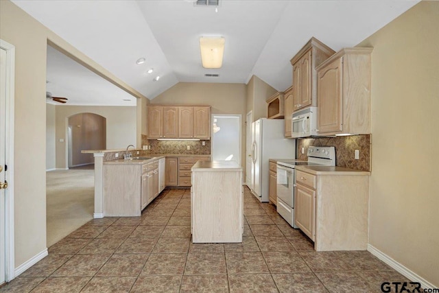 kitchen with arched walkways, light brown cabinetry, vaulted ceiling, a sink, and white appliances