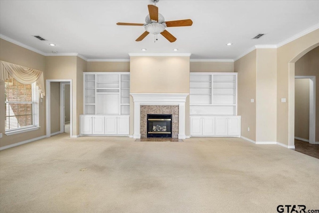 unfurnished living room with baseboards, a tile fireplace, visible vents, and light colored carpet