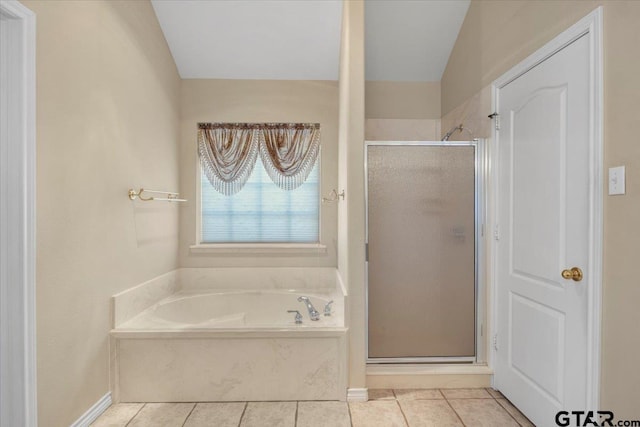 bathroom with a stall shower, a garden tub, and tile patterned floors