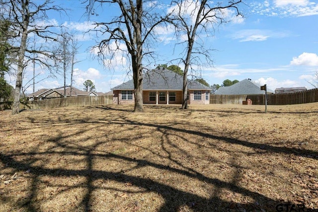 back of property featuring a fenced backyard