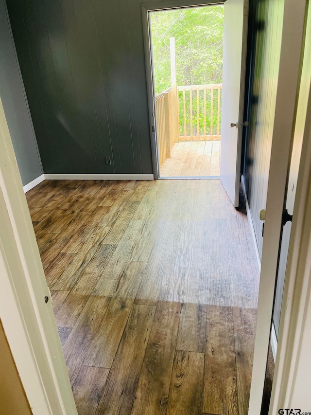 spare room with wooden walls and hardwood / wood-style floors