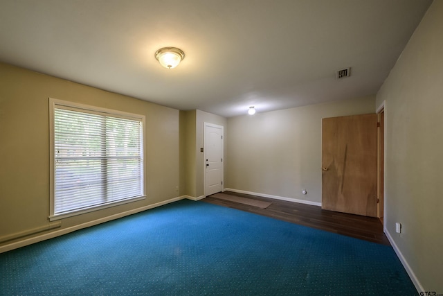 2929 Dinah Ln, Tyler, TX 75701 - unfurnished room featuring dark carpet and dark wood-type flooring