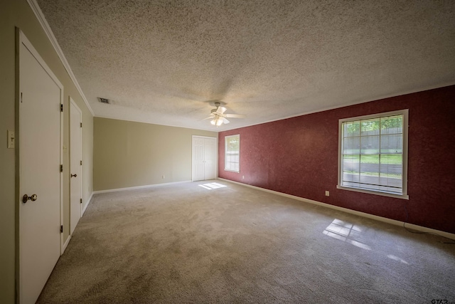 2929 Dinah Ln, Tyler, TX 75701 - carpeted empty room featuring a ceiling fan, a textured ceiling, and crown molding