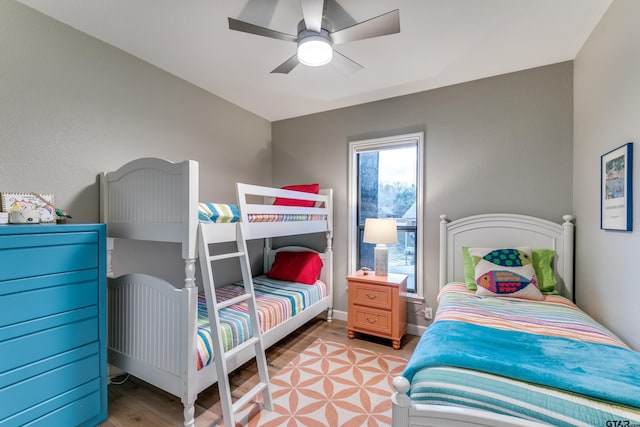 bedroom with ceiling fan, baseboards, and light wood-style floors