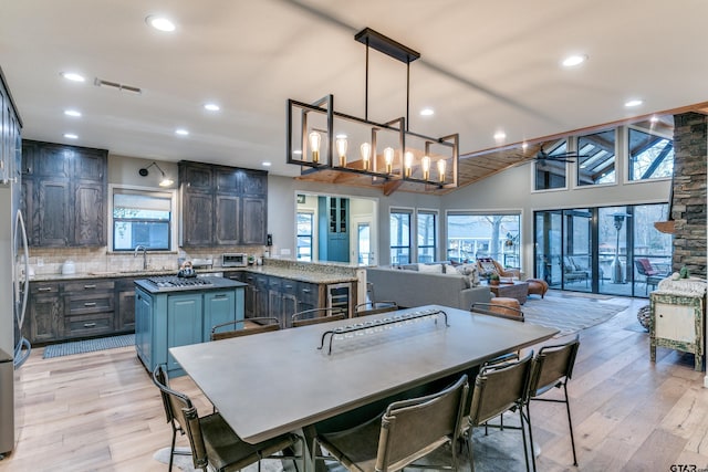 dining space featuring recessed lighting, a healthy amount of sunlight, visible vents, and light wood finished floors