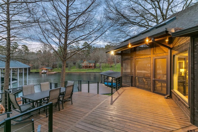 wooden deck featuring a water view and a dock