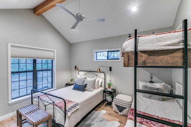 bedroom featuring vaulted ceiling with beams, baseboards, light wood finished floors, and ceiling fan