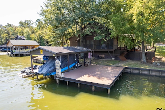 dock area with stairway, a water view, and boat lift