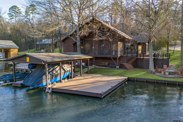 dock area with stairway, a yard, a water view, and boat lift