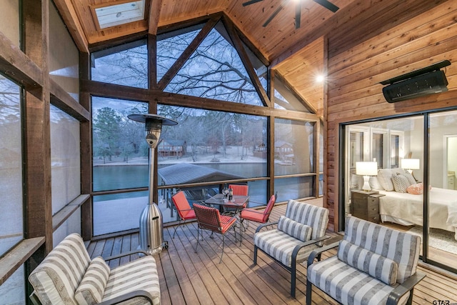 sunroom / solarium with vaulted ceiling, wood ceiling, and ceiling fan