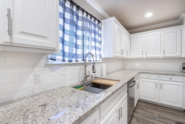 kitchen featuring white cabinets, dishwasher, crown molding, and a sink