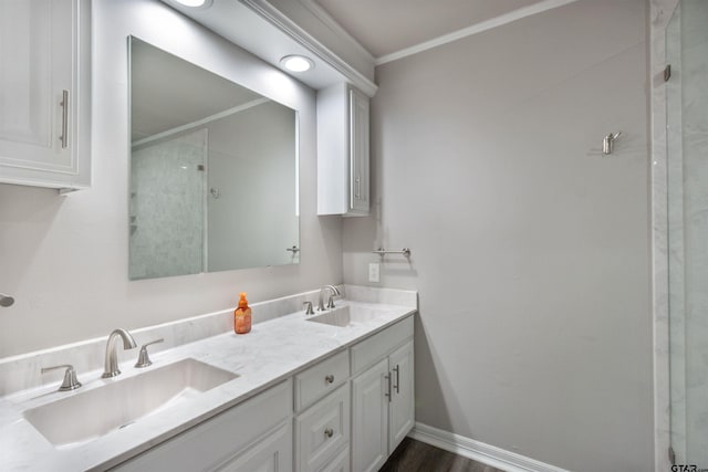 full bathroom featuring baseboards, a shower with door, and a sink