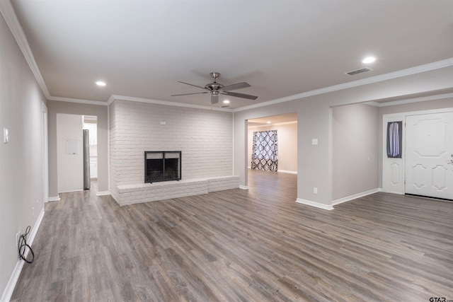 unfurnished living room featuring baseboards, a brick fireplace, wood finished floors, and a ceiling fan