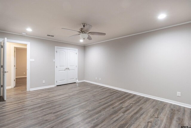 unfurnished bedroom with crown molding, recessed lighting, wood finished floors, and baseboards