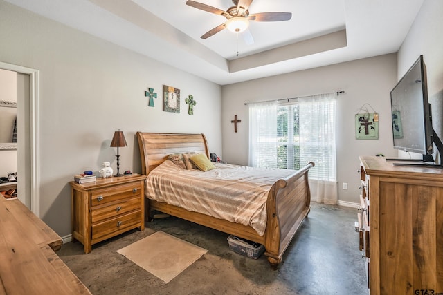 1366 N US Highway 69, Mineola, TX 75773 - bedroom with unfinished concrete flooring, baseboards, a tray ceiling, and ceiling fan
