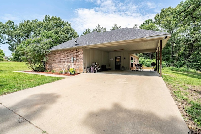 1366 N US Highway 69, Mineola, TX 75773 - view of side of home with a yard, roof with shingles, concrete driveway, and a carport