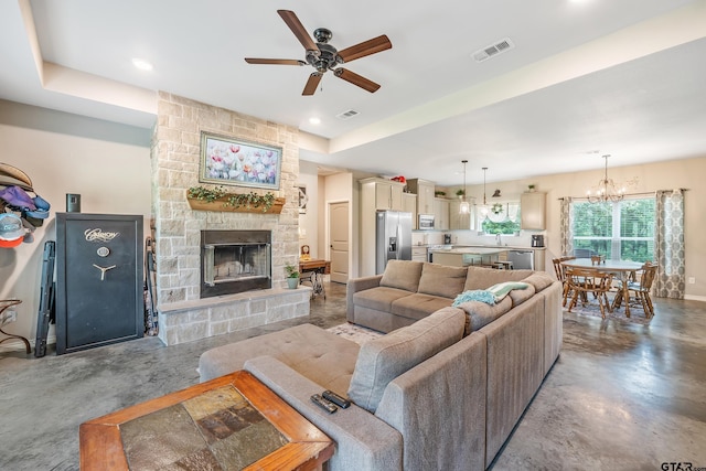 1366 N US Highway 69, Mineola, TX 75773 - living area featuring concrete flooring, ceiling fan, a fireplace, a chandelier, and recessed lighting