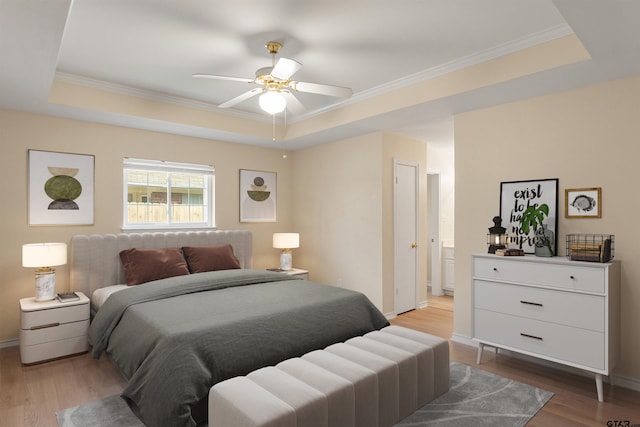 bedroom featuring hardwood / wood-style floors and a raised ceiling