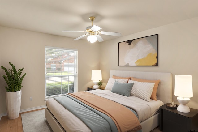 bedroom with ceiling fan and light hardwood / wood-style floors