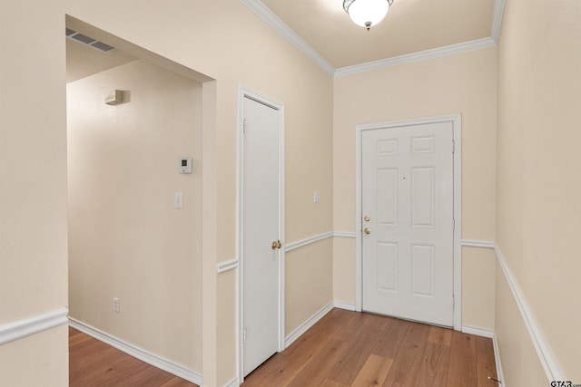 corridor featuring light wood-type flooring and ornamental molding