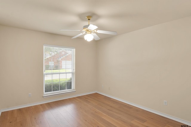 spare room with ceiling fan and light wood-type flooring