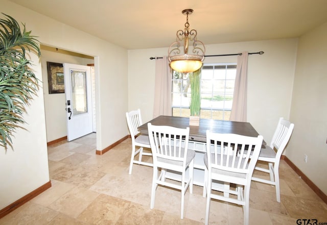 dining space featuring baseboards