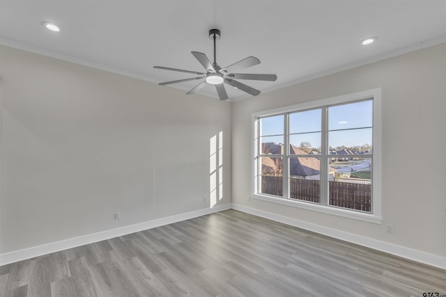 spare room with light hardwood / wood-style flooring, ceiling fan, and ornamental molding