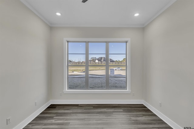 spare room with dark wood-type flooring and ornamental molding