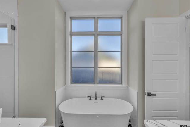 bathroom featuring a tub to relax in