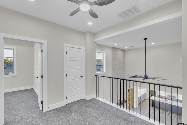 hallway featuring carpet and a wealth of natural light