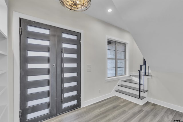 foyer entrance featuring hardwood / wood-style floors and lofted ceiling