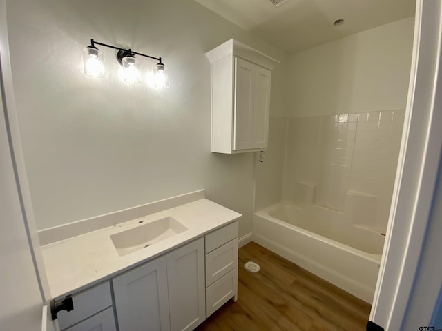 full bathroom featuring a sink, a bathing tub, a shower, and wood finished floors