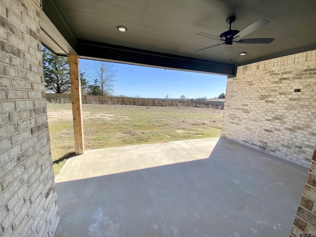 view of patio / terrace with a ceiling fan and fence