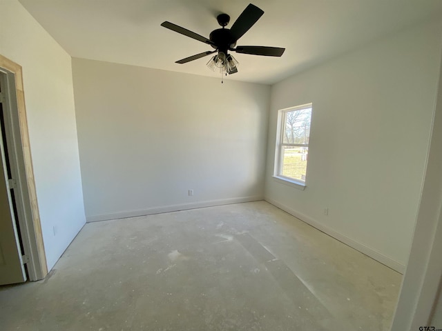 unfurnished room with unfinished concrete flooring, baseboards, and ceiling fan