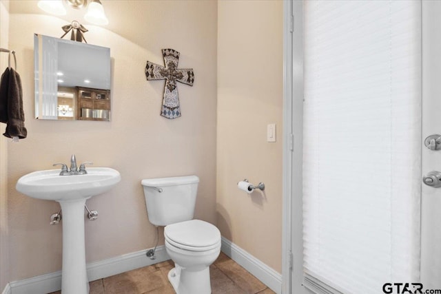 bathroom with toilet and tile patterned floors