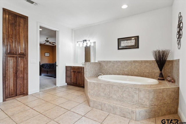 bathroom featuring vanity, tiled bath, tile patterned floors, and ceiling fan