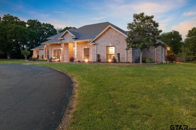 view of front facade with a garage and a lawn