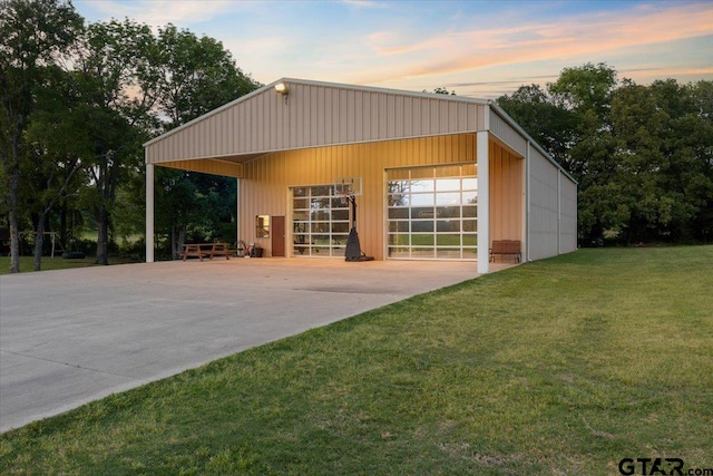 exterior space with an outbuilding and a lawn