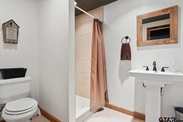 bathroom featuring tile patterned floors, toilet, and a shower with curtain