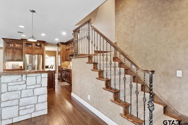 stairs featuring hardwood / wood-style floors