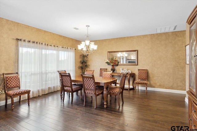 dining space with an inviting chandelier and dark hardwood / wood-style flooring