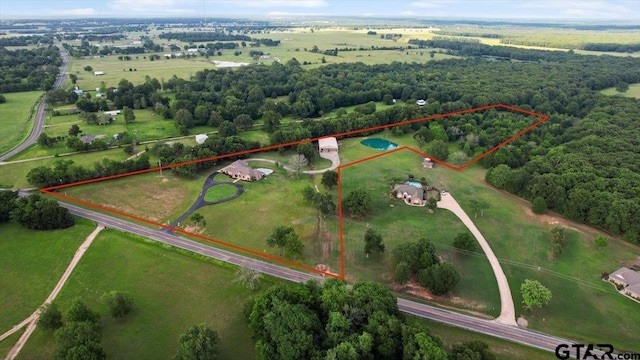 birds eye view of property with a rural view