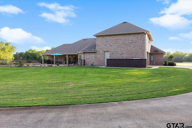 view of property exterior with a patio and a yard