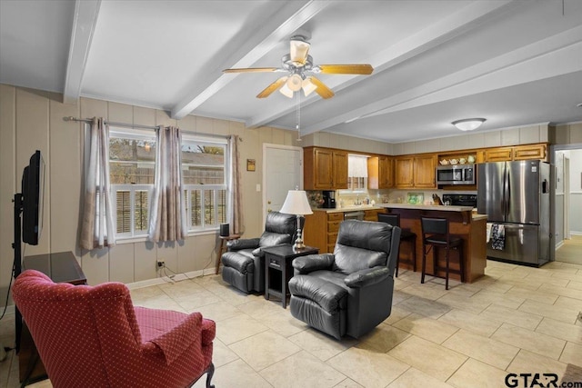 living room with ceiling fan, beam ceiling, light tile patterned flooring, and crown molding