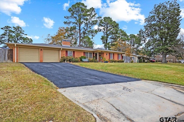 ranch-style house with a garage and a front lawn