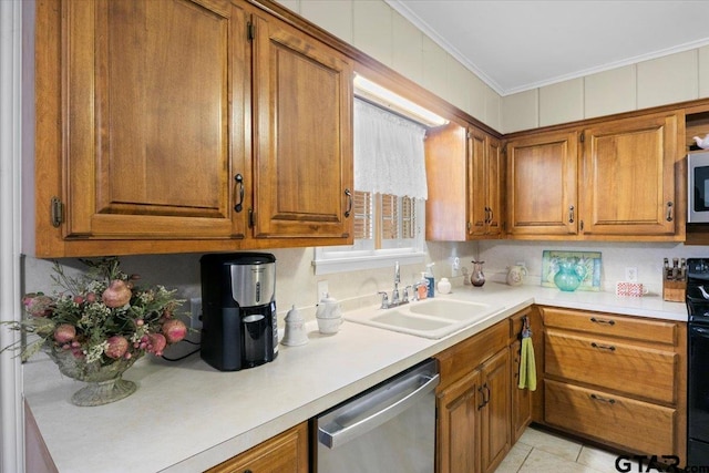 kitchen featuring sink, light tile patterned floors, crown molding, and appliances with stainless steel finishes