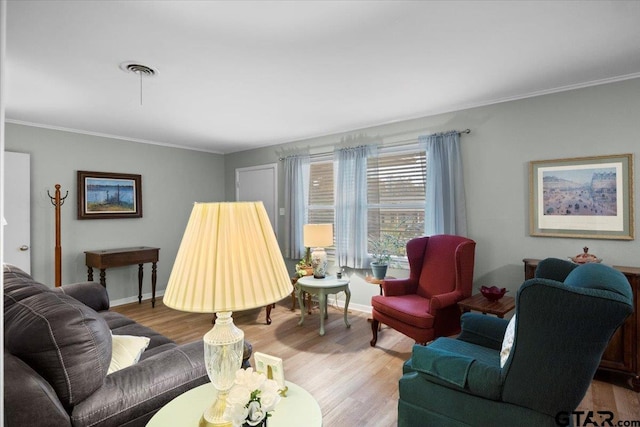 living room featuring hardwood / wood-style flooring and ornamental molding