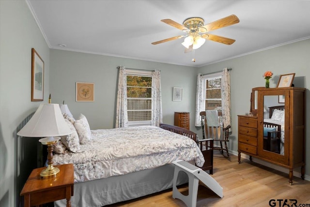 bedroom featuring ceiling fan, light wood-type flooring, and crown molding