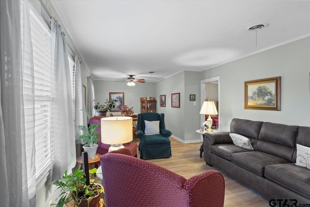 living room with ceiling fan, light hardwood / wood-style floors, and ornamental molding